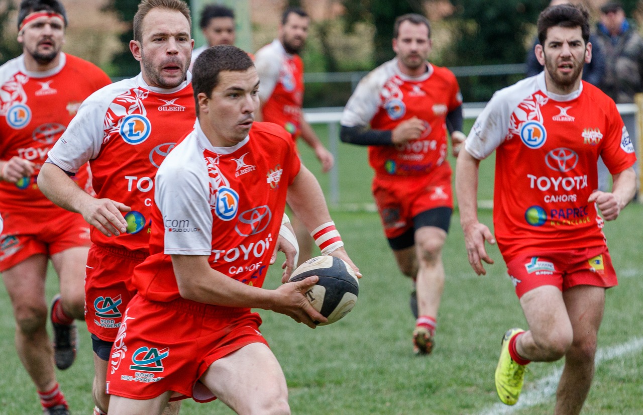 Rugby players running with the ball